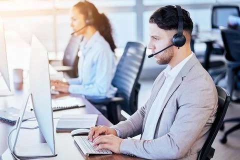 Call center, computer and typing man in office for customer service, technical Stock Photos