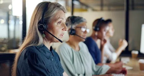 Call center, customer support and telemarketing with a senior woman at work as a Stock Photos