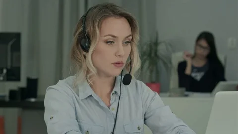 Call center employee making notes while talking with customer 스톡 동영상 71126672