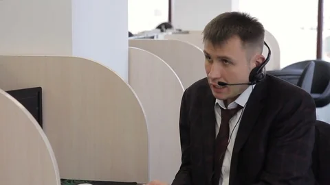 Call center employee talking while sitting in modern office. Stock Footage 85448698