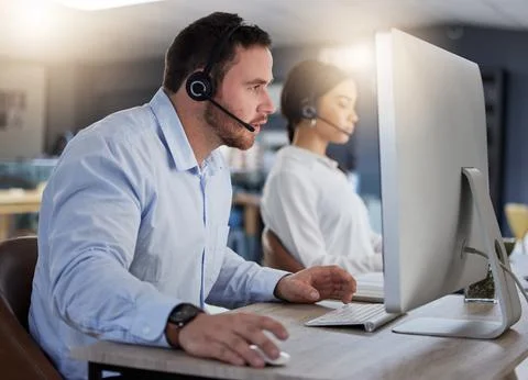 Call center, focus and computer with man in office for communication, customer Foto stock