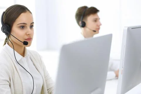 Call center. Group of operators at work. Focus on beautiful woman receptionist Stock Photos