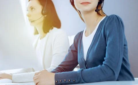 Call center. Group of operators at work. Focus on beautiful woman receptionist Stock Photos