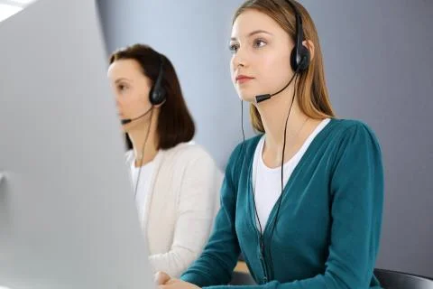 Call center. Group of operators at work. Focus on beautiful woman receptionist Stock Photos