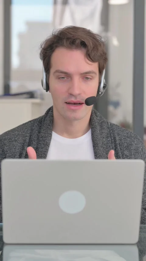Call Center Man with Headset Talking Online with Customer, vertical video Stock Footage 324792731