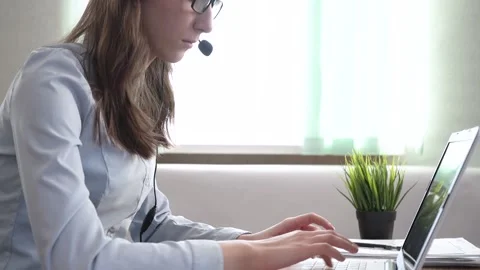 The call center manager is typing on a laptop. Stock Footage 182045169