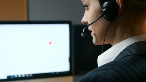 Call center operator answers the call and communicates with the client. Back Stock Footage 103463311