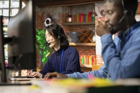 Call center operator assisting users with installing software 写真素材