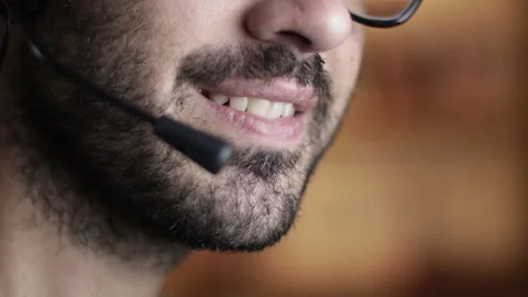 Call center operator with headset, closeup of mouth, shallow depth of field Stock Footage 161278980