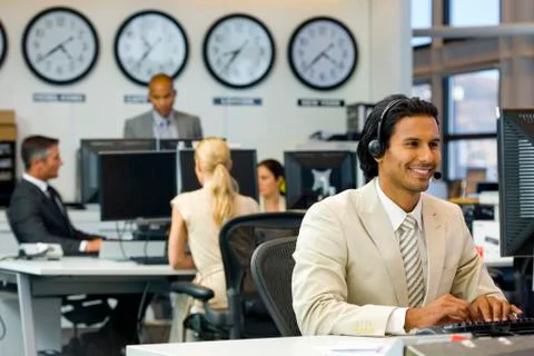 Call center operator in open space office Stock Photos