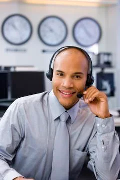 Call center operator in open space office Stock Photos
