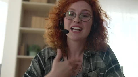 Call center operator smiling and talking on a video call Stock Footage 333261354