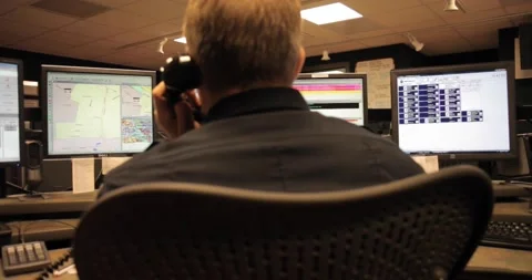Call Center Operator Talking on Phone While Monitoring Data Screens Stock Footage 230912599