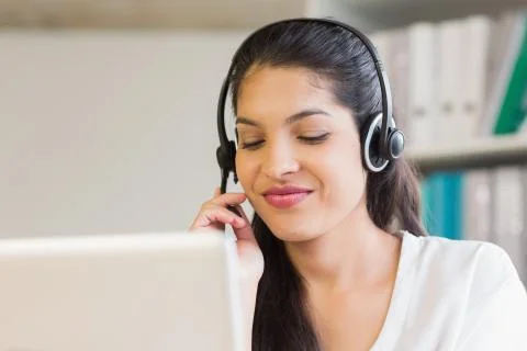 Call center representative using headset 스톡 사진