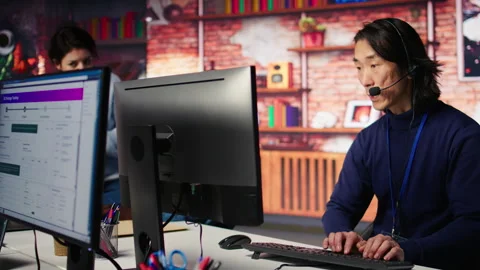 Call center senior agent providing guidance to help customers using AI Stock Footage 305398810