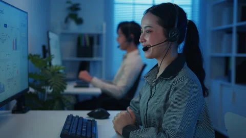 Call center team customer support service work support in night office. 動画素材 333942343