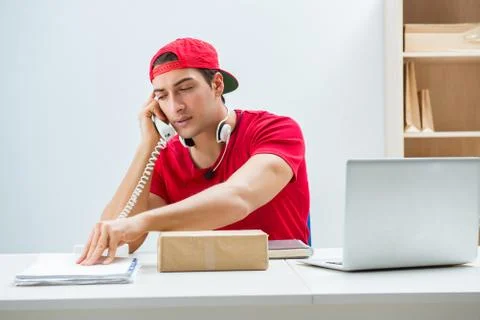 Call center worker at parcel distribution center in post office Stockfoto's