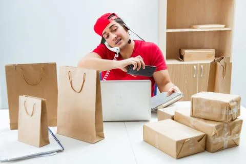Call center worker at parcel distribution center in post office Stockfoto's