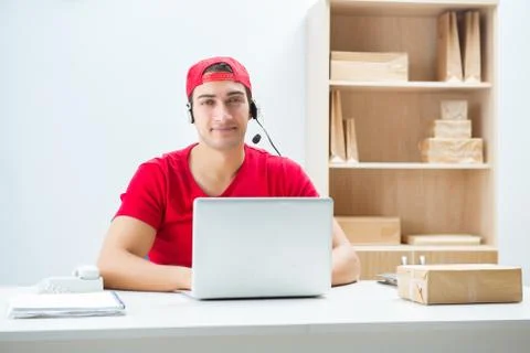 Call center worker at parcel distribution center in post office Stockfoto's