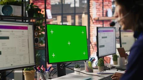 Call center worker solving customers issues using green screen PC Stock Photos