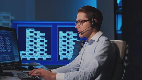 Call-center worker is speaking with the client by headset. Workplace of the Stock Footage 145716495