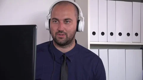 Call center young worker man with headphone explaining cheerful telesales agent Stock Footage