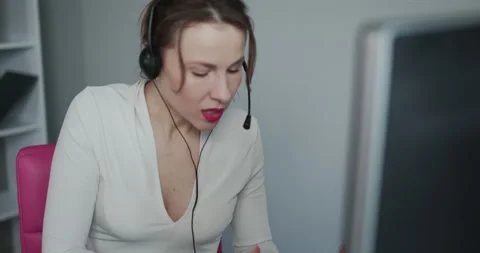 Call Centre Agent Working in Their Bright Office. Call center employee at work Stock Footage 194512367