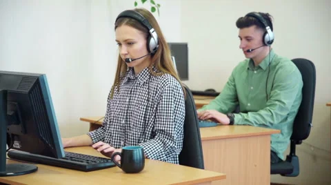 Call centre agents working in their bright office Stock Footage 61722554