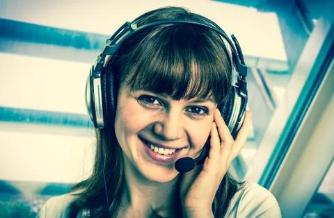 Call centre operator with headset at workplace in call center Stock Photos