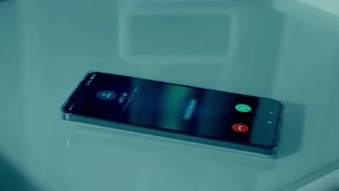 A call comes through on a smartphone and a man's hand picks it up to answer Stock Footage 297764095