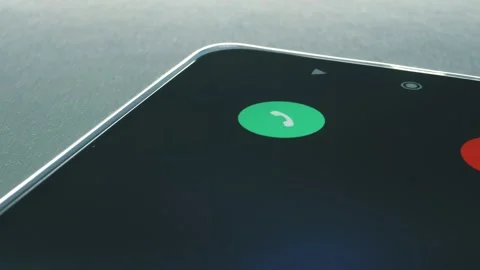 A call comes through on a smartphone and a man's hand picks it up to answer Stock Footage 297766624