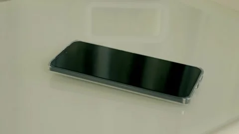 A call comes through on a smartphone and a man's hand picks it up to answer Stock Footage 297783995