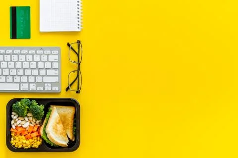 Call for delivery concept. Lunch boxes with meal on working place Stock Photos