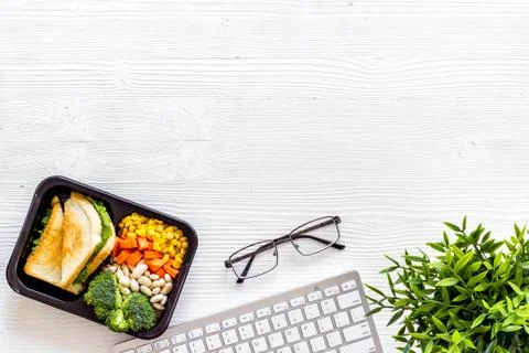 Call for delivery concept. Lunch boxes with meal on working place Stock Photos