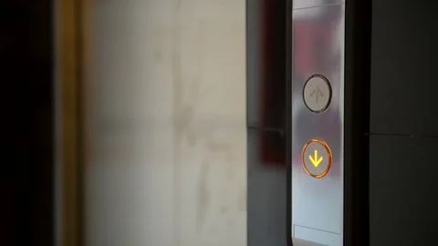 Call down a modern elevator and comes in it Stock Footage 77178780