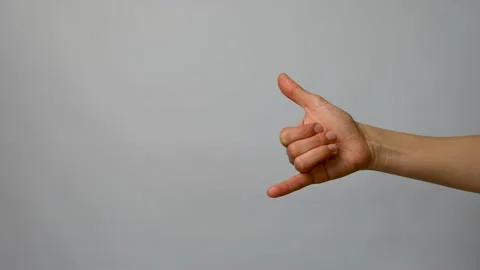 Call me gesture on grey background, close-up Stock Footage 238355280