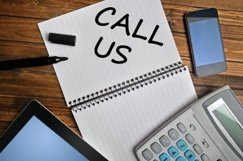 Call Us words on notebook Stock Photos