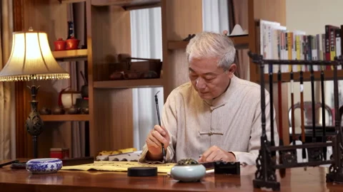 The calligrapher artist practicing traditional calligraphy with ink brush Stock Footage 340184560