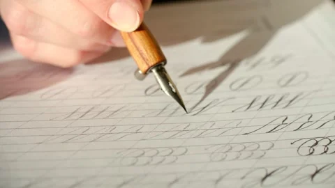 Calligrapher writing cursive letters with dip pen Stock Footage 324005320