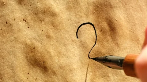 Calligrapher writing question mark with ink pen Stock Footage 323897241