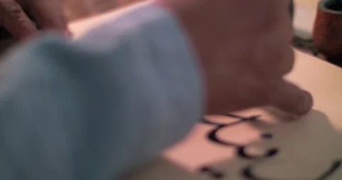 A calligraphers hand dips a stylo into an inkwell and writes a letter on Stock Footage 310531268