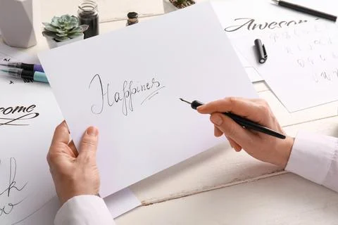 Calligraphy practice with "happiness" word, creative writing and artistic exp Stock Photos