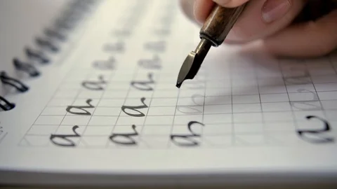 Calligraphy in slow motion. Selective focus close-up shot of hand written page Video stock 128243106