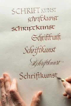 Calligraphy studio hand writes text with ink pen and nib Antiqua writing on Foto stock