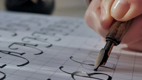 Calligraphy on sun light. Writing with nib fountain pen, black ink on white Stock Footage 128268283