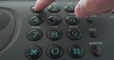 Calling 911, push buttons on old vintage red fax keypad, male hand presses the Stock Footage 289302148