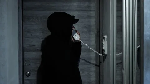 Calling a home intercom in an apartment, talking on a wired wall telephone. Stock Footage 263662711