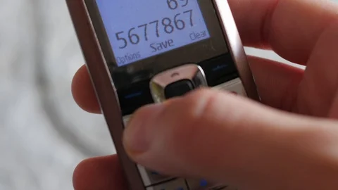 Calling on outmoded, old school model of  mobile phone Stock Footage 87184510