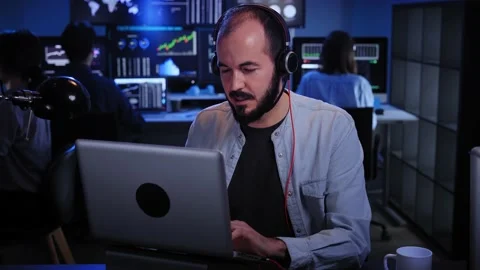 Calling Stock Market Trader Working on Computer with Multi-Monitor Workstation Stock Footage 229503083