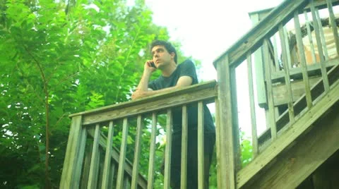 Calling summer cell phone talking talk outside communicate outdoors deck Stock Footage